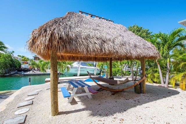 surrounding community with a gazebo and a water view