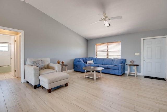 living room with ceiling fan, a healthy amount of sunlight, lofted ceiling, and light wood-type flooring