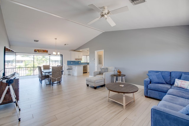 living room with lofted ceiling, ceiling fan with notable chandelier, and light wood-type flooring