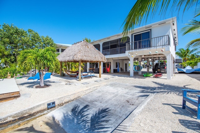 back of property with a gazebo and a patio