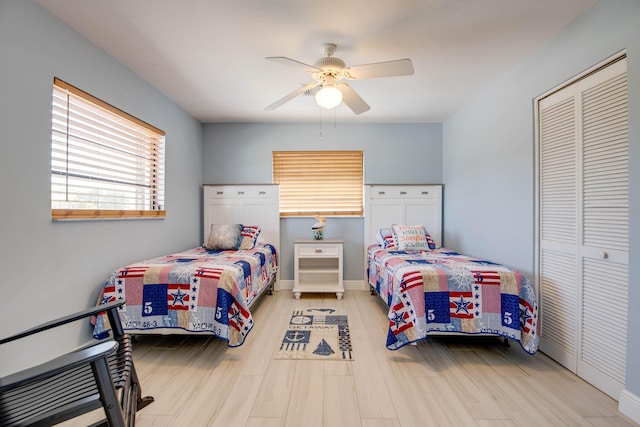 bedroom featuring light hardwood / wood-style floors, a closet, and ceiling fan