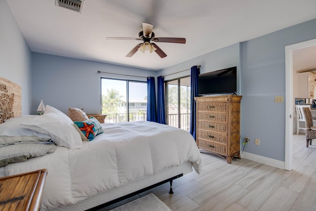 bedroom featuring access to exterior, light hardwood / wood-style flooring, and ceiling fan