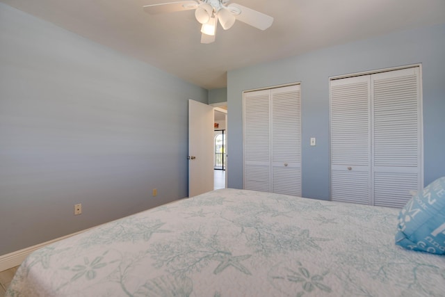 bedroom featuring multiple closets and ceiling fan