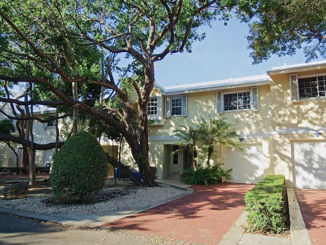 97501 Overseas Hwy Unit 809, Key Largo, FL 33037 - view of front of house featuring stucco siding, an attached garage, and concrete driveway
