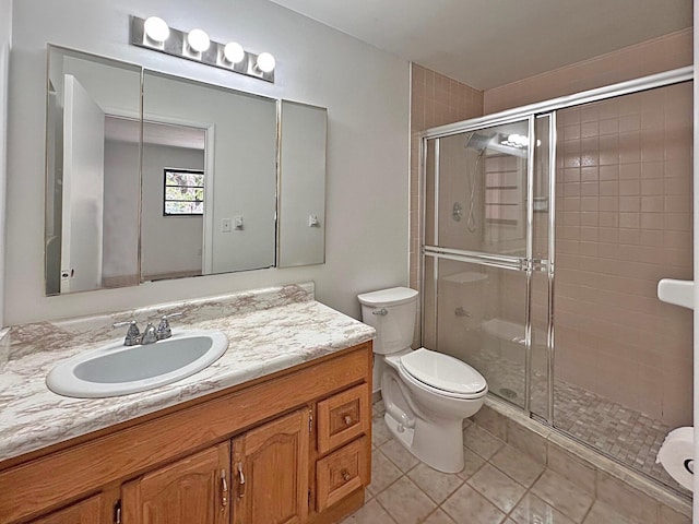 full bath featuring tile patterned floors, a stall shower, toilet, and vanity