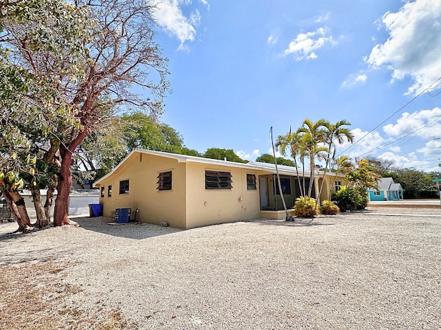 view of front of house featuring stucco siding and central AC unit