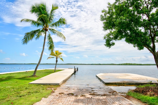 dock area with a boat ramp and a water view