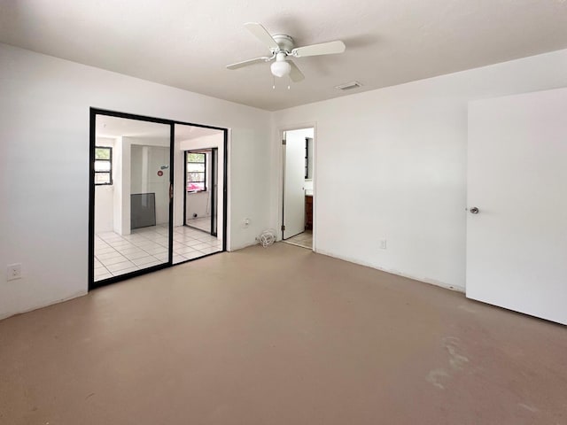 empty room featuring a ceiling fan and concrete floors