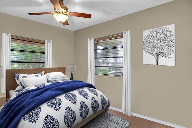 22865 Redfish Ln, Cudjoe, FL 33042 - bedroom with multiple windows, carpet floors, a ceiling fan, and baseboards