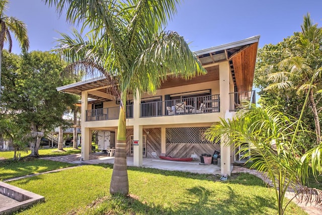 22865 Redfish Ln, Cudjoe, FL 33042 - rear view of property featuring a patio area, a yard, and a balcony