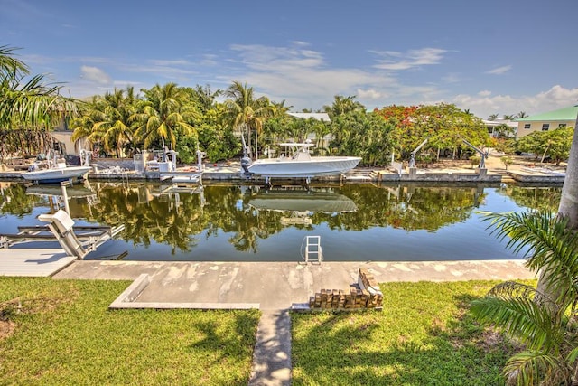22865 Redfish Ln, Cudjoe, FL 33042 - dock area with boat lift, a water view, and a yard