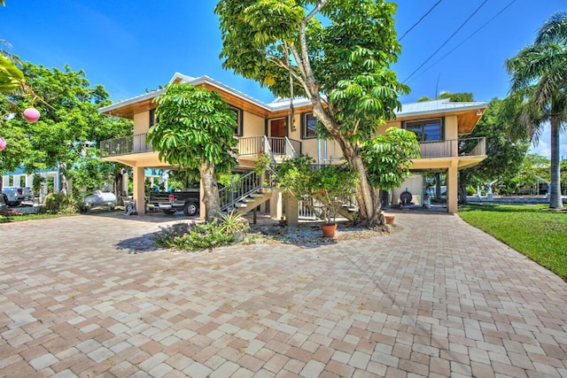 22865 Redfish Ln, Cudjoe, FL 33042 - view of property featuring a carport, decorative driveway, and stairway