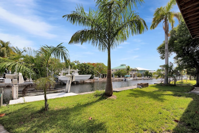 22865 Redfish Ln, Cudjoe, FL 33042 - view of green lawn featuring boat lift, a dock, and a water view