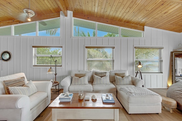 living room with vaulted ceiling with beams, wood ceiling, and light hardwood / wood-style floors