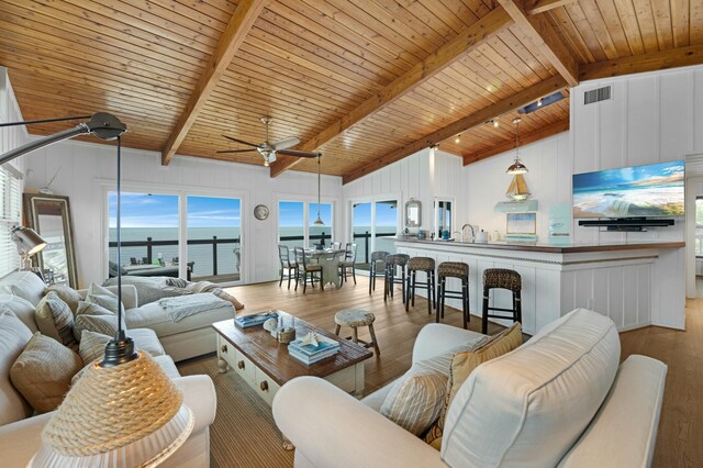 living room featuring wood ceiling, beam ceiling, and light hardwood / wood-style floors