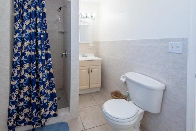 bathroom featuring tile patterned flooring, tile walls, a shower with shower curtain, vanity, and toilet