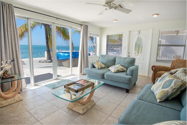 sunroom with a water view, a wealth of natural light, and ceiling fan