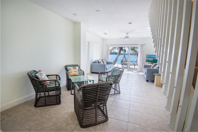 sitting room with light tile patterned floors and ceiling fan