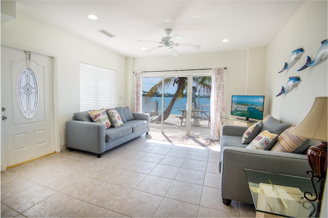 tiled living room with ceiling fan