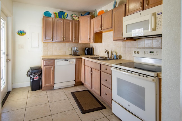 kitchen with white appliances, sink, decorative backsplash, and light tile patterned floors