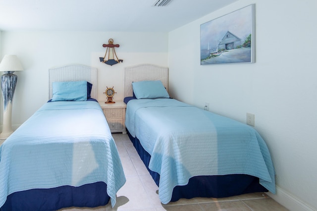 bedroom with light tile patterned flooring