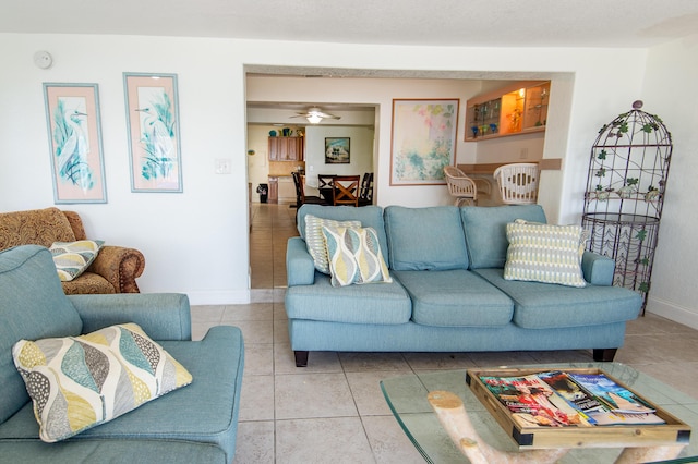 tiled living room featuring ceiling fan