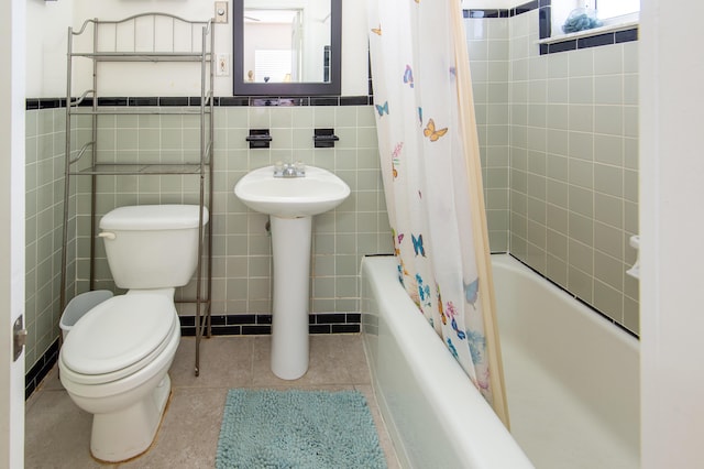 full bathroom featuring sink, tile walls, tile patterned flooring, shower / bath combination with curtain, and toilet