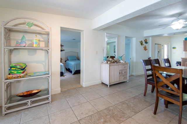 tiled dining area with ceiling fan