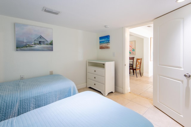 bedroom with light tile patterned floors