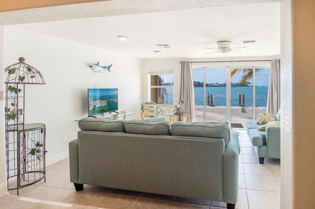 tiled living room with ceiling fan