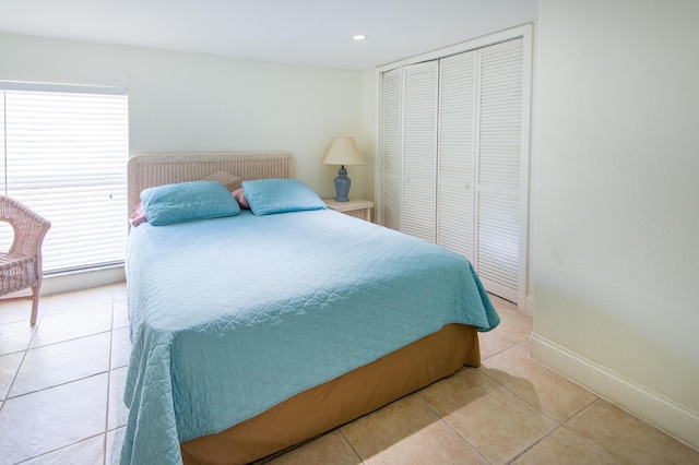 tiled bedroom featuring a closet