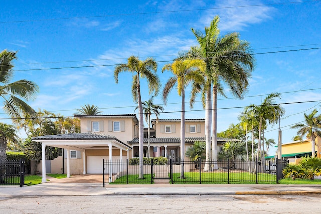 3300 Riviera Dr, Key West, FL 33040 - view of front facade with concrete driveway, stucco siding, a carport, a fenced front yard, and a tile roof