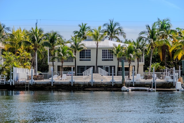 exterior space featuring a water view and fence