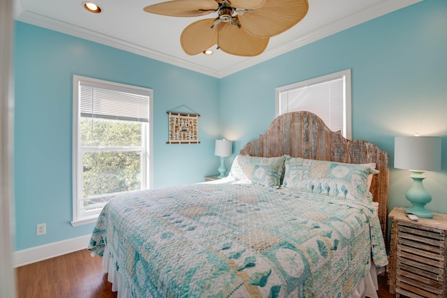 bedroom featuring hardwood / wood-style flooring, ornamental molding, and ceiling fan