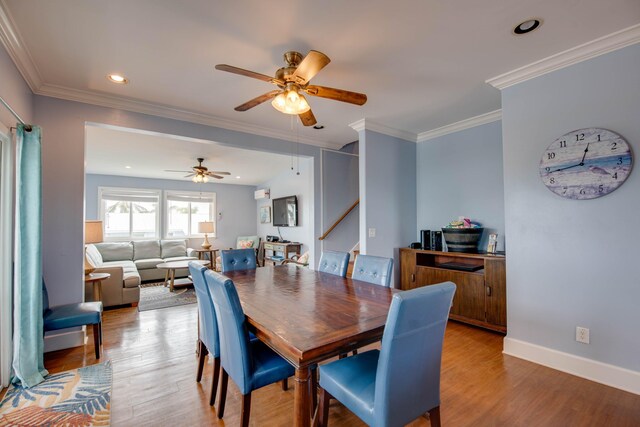 dining space with crown molding, ceiling fan, and light wood-type flooring