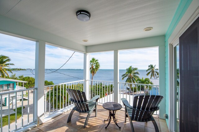 sunroom / solarium with a water view