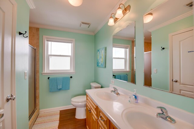 bathroom with hardwood / wood-style flooring, crown molding, an enclosed shower, and toilet