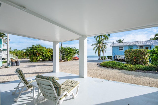 view of patio with a water view