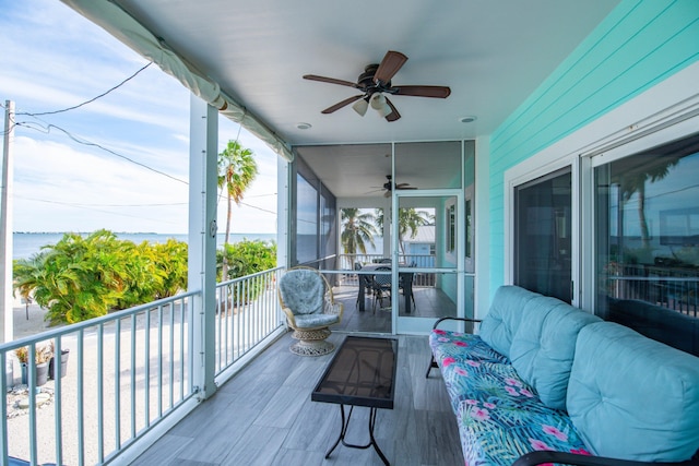 sunroom / solarium with a water view