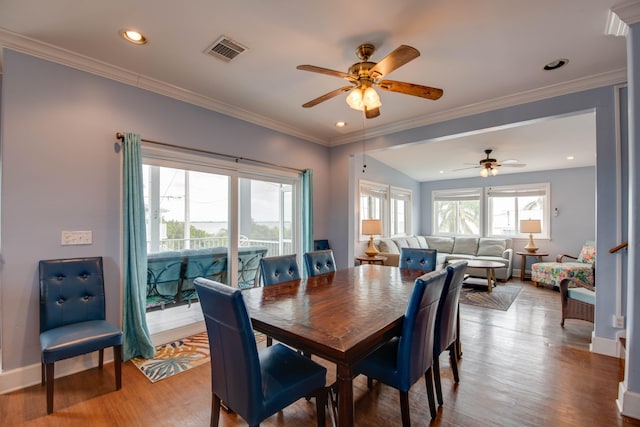 dining area with hardwood / wood-style flooring, ceiling fan, and ornamental molding