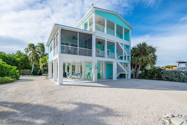 view of front of home featuring ceiling fan, a balcony, and a patio