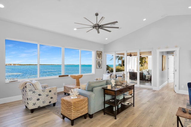 living room featuring high vaulted ceiling, light hardwood / wood-style floors, and ceiling fan