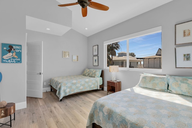 bedroom featuring vaulted ceiling, ceiling fan, and light wood-type flooring