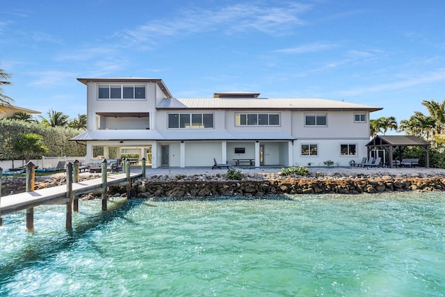 rear view of property with a patio area and a water view