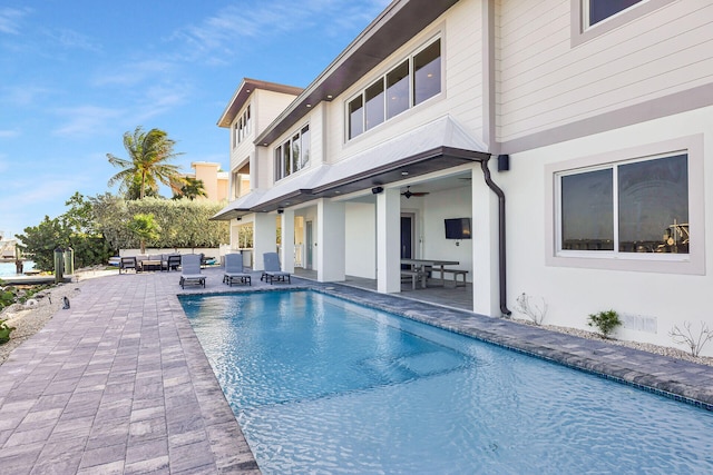 view of pool featuring outdoor lounge area, ceiling fan, and a patio area