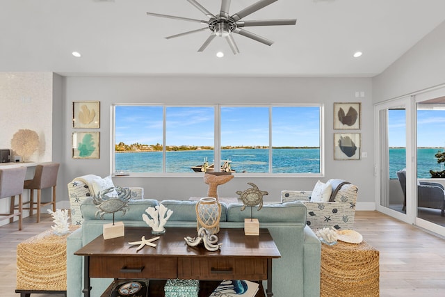 living room featuring vaulted ceiling, ceiling fan, a water view, and light hardwood / wood-style floors