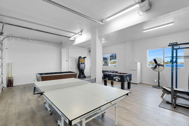 recreation room with a healthy amount of sunlight, pool table, and light hardwood / wood-style flooring