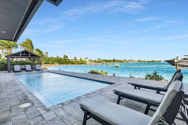 view of pool with a gazebo, a patio, and a water view