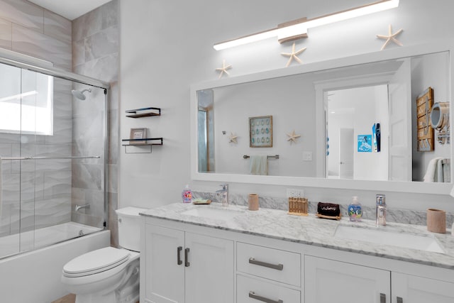 full bathroom featuring vanity, toilet, and combined bath / shower with glass door