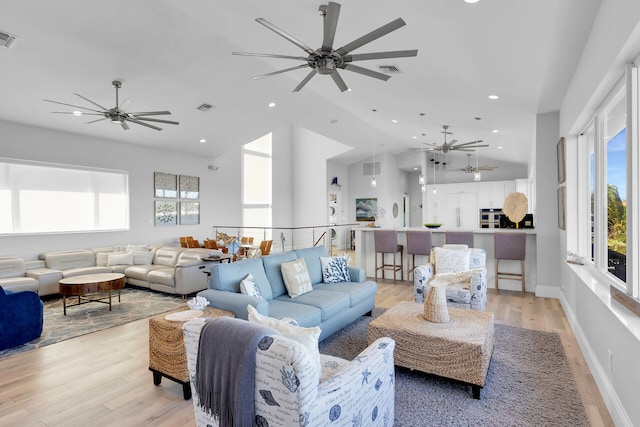 living room featuring ceiling fan, a healthy amount of sunlight, and light wood-type flooring